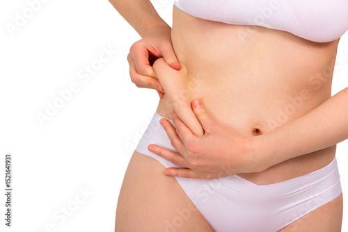 Woman showing excess skin on belly, side with hands. Abdominal plastic surgery concept, weight loss, fat removal, close-up