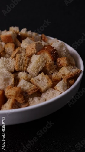 Fried bread croutons on a white plate close-up