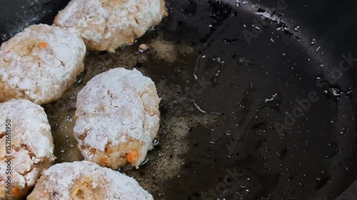 Frying pan with fish cakes and sizzling oil close-up, cooking homemade food, lifestyle