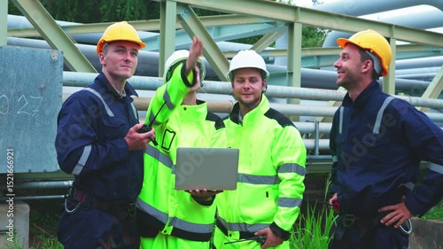 Engineers Reviewing Data at Industrial Site at Night