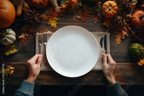 Preparing for a Festive Autumn Meal Surrounded by Seasonal Decorations and Ha...