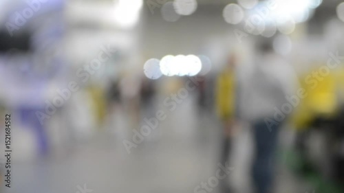 Wallpaper Mural People walking in building. Building with walls, floor, ceiling illuminated lamps. Silhouettes of people indoors. Many people walking. Men and women in tall hall. Exhibition center. Blurred background Torontodigital.ca