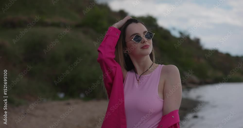 Charmed chic woman turning face back on a nature, throwing hair, slow motion Charmed chic woman turning face back on a nature, throwing hair, slow motion