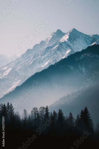 Majestic Snow-Capped Mountains Rise Above Misty Valleys in Early Morning Light