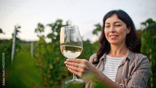 Tableau sur toile Happy Caucasian woman smiling with joy while looking at glass of white wine