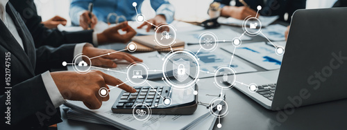 Business meeting on security measures showcasing teamwork and technology with data visualization, charts, and a calculator in a modern office setting. Amity photo