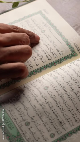 Man Engaged in Quran Study vertical