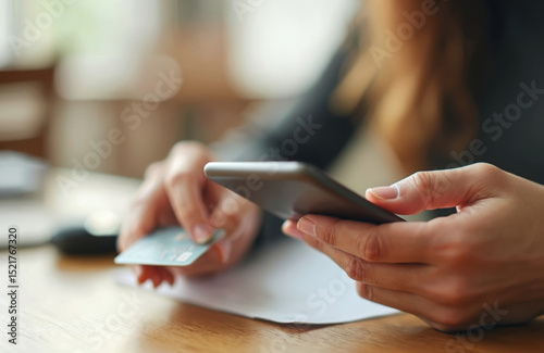 Woman uses credit card for online payment with smartphone. Person makes wireless electronic transaction. Safe shopping via mobile phone. E-commerce, banking, financial operations in digital world.
