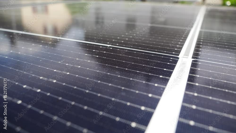 Close-up view of black long solar panels placed on a courtyard of a house