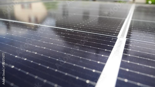 Close-up view of black long solar panels placed on a courtyard of a house