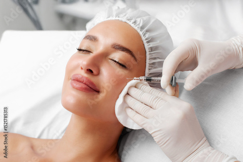 Beauty specialist injecting dermal filler in crows feet or upper eyelid. Aesthetic face skin eye wrinkle treatment concept