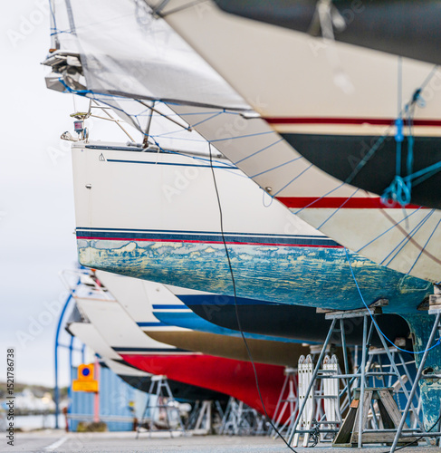 Closeup view of sailboat hulls on stands.