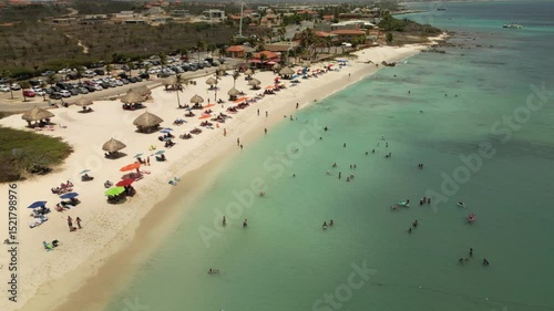 4K drone video of people sunbathing and enjoying the tranquil beauty of Arashi Beach, Aruba. Captures the relaxed vibe of a Caribbean getaway—perfect for travel promotions or leisure content photo