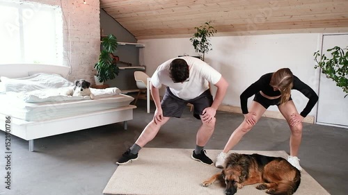 couple training at home in the bedroom, dogs lying around , healthy lifestyle