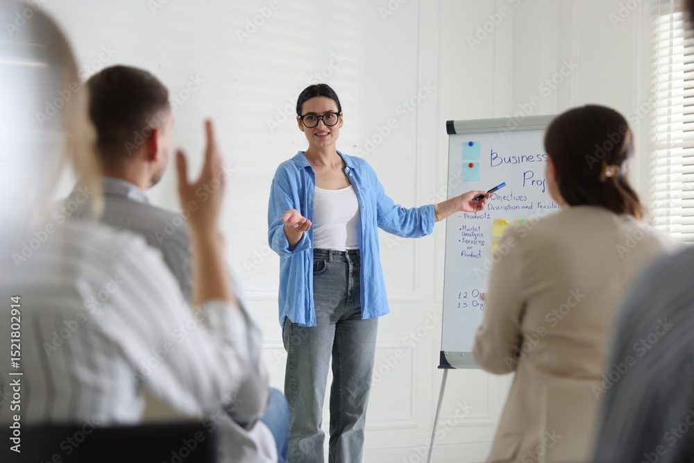 Fototapeta premium Woman giving public speech in front of audience indoors