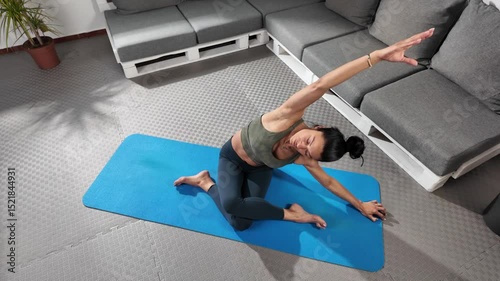 A person performs an impressive stretch routine in a modern yoga studio, showcasing various poses that enhance flexibility and strengthen the body.