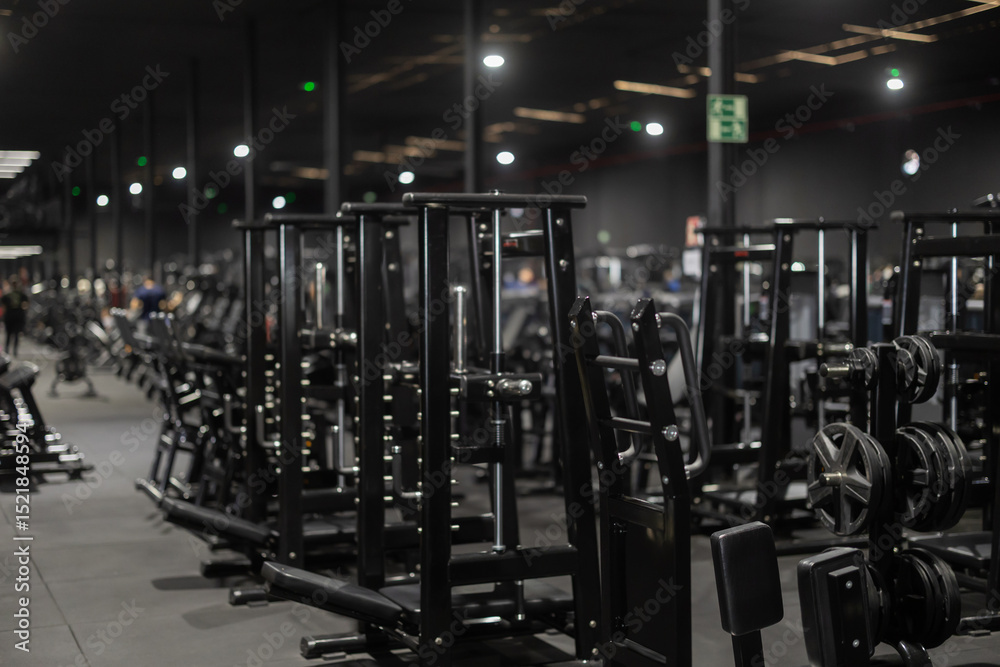 Fototapeta premium Fitness room with equipment and exercise machines. Space for physical activity, exercise, health and active hobbies.