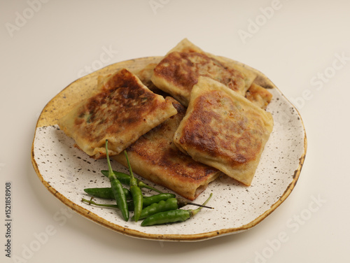 Folded pastry filled with meat filling and fried until golden brown