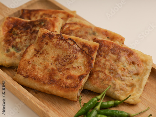 Folded pastry filled with meat filling and fried until golden brown
