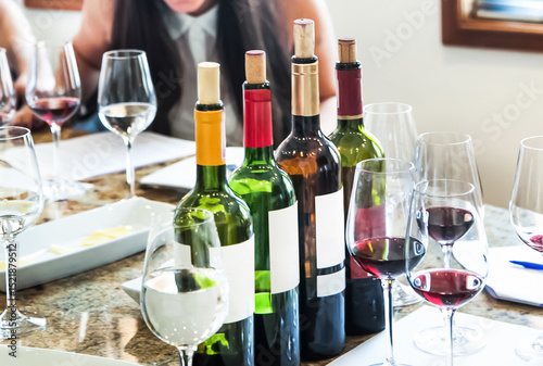 Sommeliers tasting wine bottles during winetasting session