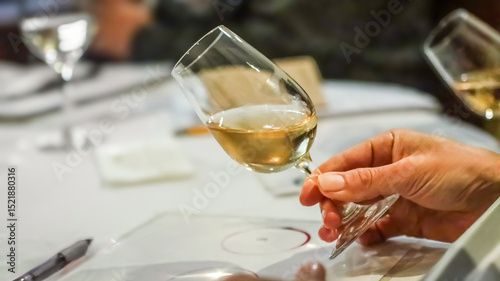 Sommelier evaluating white wine during tasting session