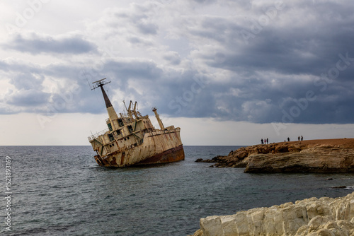 Old rust ship wreck on a rocky coast  in Mediterranean sea at Akrotiri Beach in Cyprus. Shipwreck of the abandoned ship