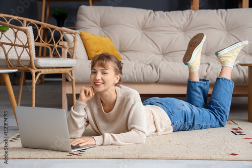 Young woman using laptop on...