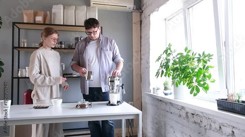 young millennial man grinding coffee at home , making coffee in the morning