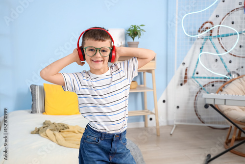 Cute little boy with headph...