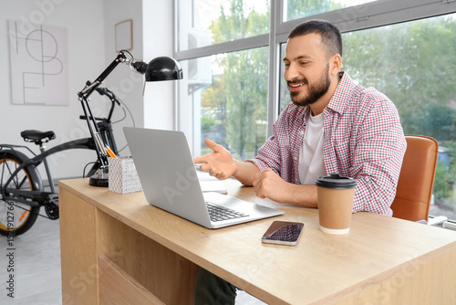 Male freelancer with laptop...