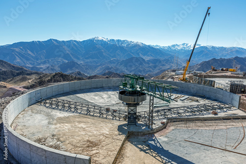 Concrete thickener is installing. Thickening is a process where a slurry or solid-liquid mixture is separated to a dense slurry containing most of the solids and an overflow of essentially clear water