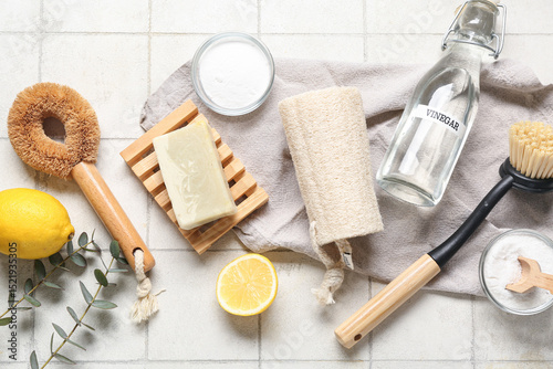 Composition with natural products and supplies for cleaning on light tile background
