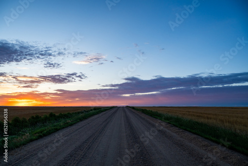 Sun Rising Over Long Dirt Road In Kansas