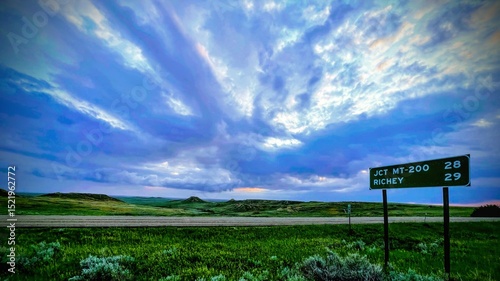 Photography A solitary road sign astride an Eastern Montana rural highway