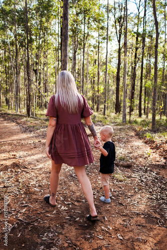 First Nations Australian mother with four year old son exploring native bushland together
