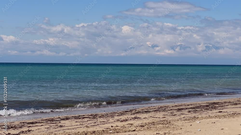 Stunning beach scene in Halkidiki, Greece, with elegant sunbeds facing the crystal-clear turquoise sea. A perfect summer escape in the heart of the Aegean. Stunning beach scene in Halkidiki, Greece, with elegant sunbeds facing the crystal-clear turquoise sea. A perfect summer escape in the heart of the Aegean.