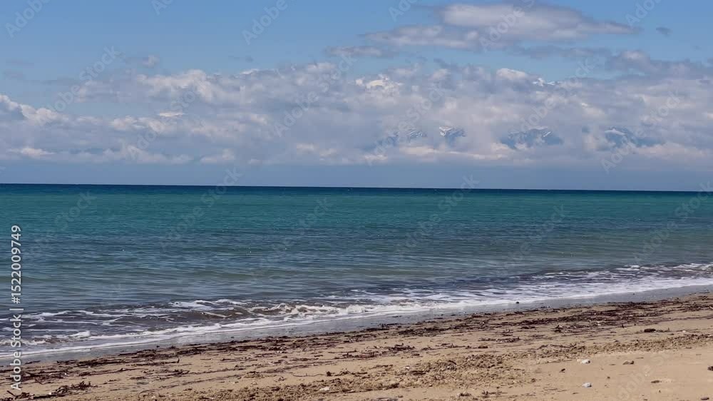 Stunning beach scene in Halkidiki, Greece, with elegant sunbeds facing the crystal-clear turquoise sea. A perfect summer escape in the heart of the Aegean. Stunning beach scene in Halkidiki, Greece, with elegant sunbeds facing the crystal-clear turquoise sea. A perfect summer escape in the heart of the Aegean.