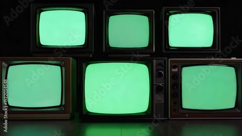 Stacked Old Televisions Showing Green Screens Symbolizing Obsolete Technology