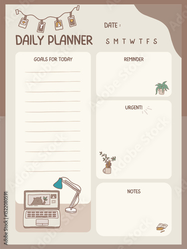 A daily planner with a laptop on it. The planner has a section for goals and a section for notes