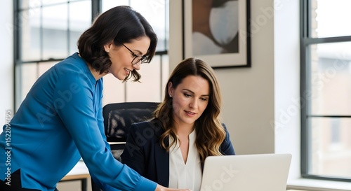 Business women collaborating on laptop in office professional teamwork and leadership concept