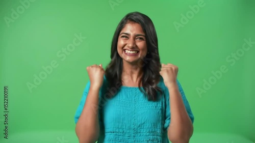 Happy woman in teal celebrating success