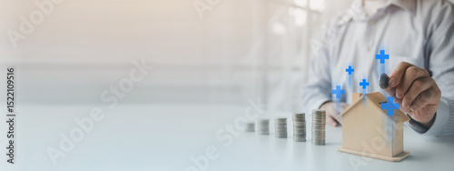 Person with savings for real estate purchase, personal financial planning concept of income allocation, expenses and investment, businessman with pile of coins and house model.