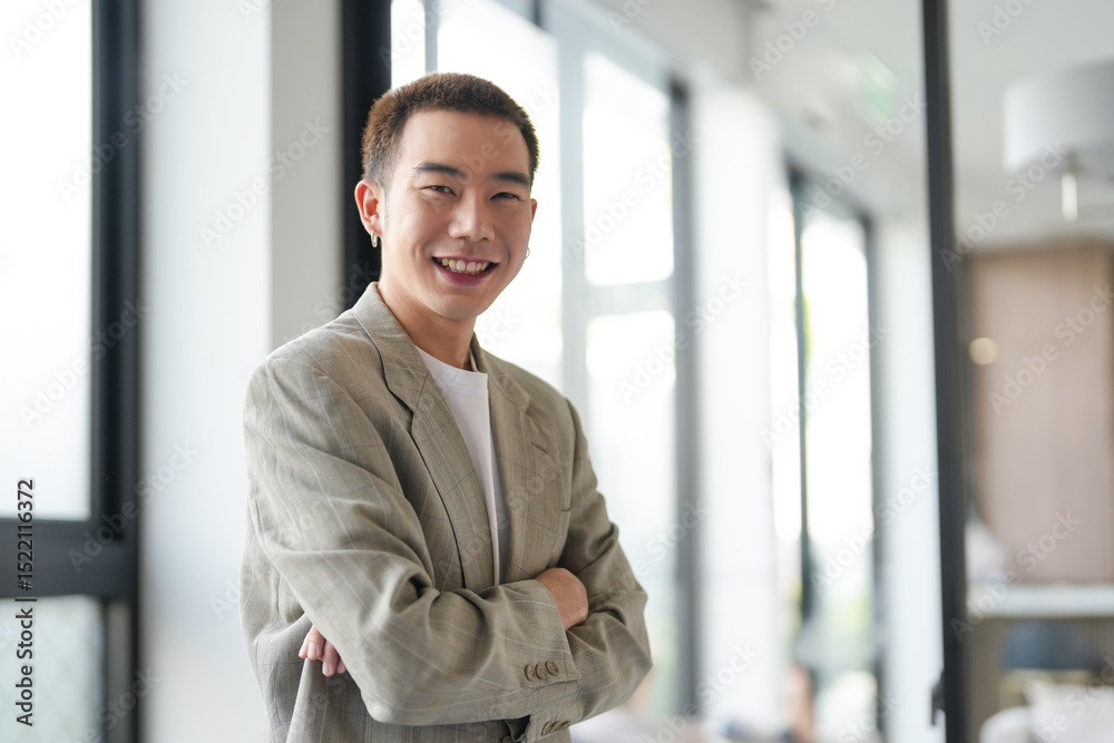 Fototapeta premium Smiling young Asian businessman in modern office. handsome asian man happy and friendly while working&nbsp;success job