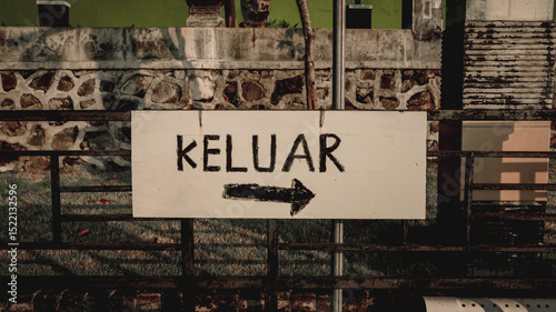 Handmade exit sign with black arrow and text 