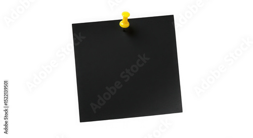Black square paper attached with yellow push pin on a dark background view