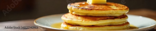 Fluffy buttermilk pancakes stacked high on a plate, golden brown and glistening with butter, ready to be devoured  A classic breakfast treat, perfect for a weekend brunch , rustic, fluffy, batter photo