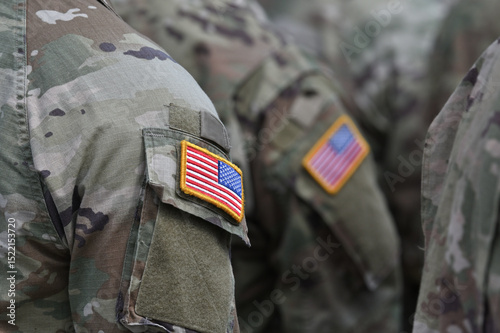 Person wearing military clothes with national symbol.