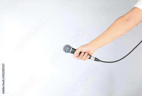Hand holding microphone on white background.