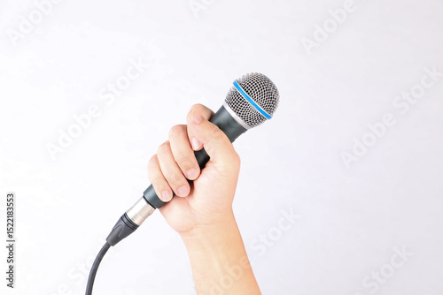 Hand holding microphone on white background.