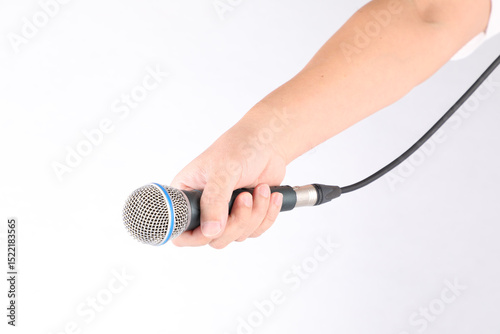 Hand holding microphone on white background.